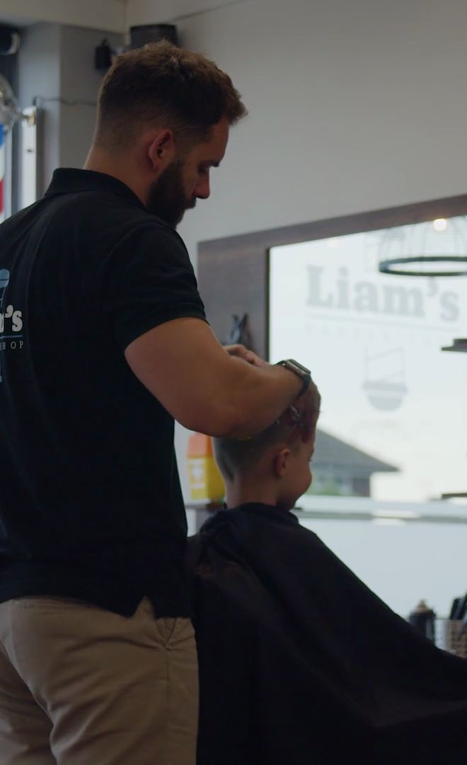 A barber at work at Liam's Barbershop